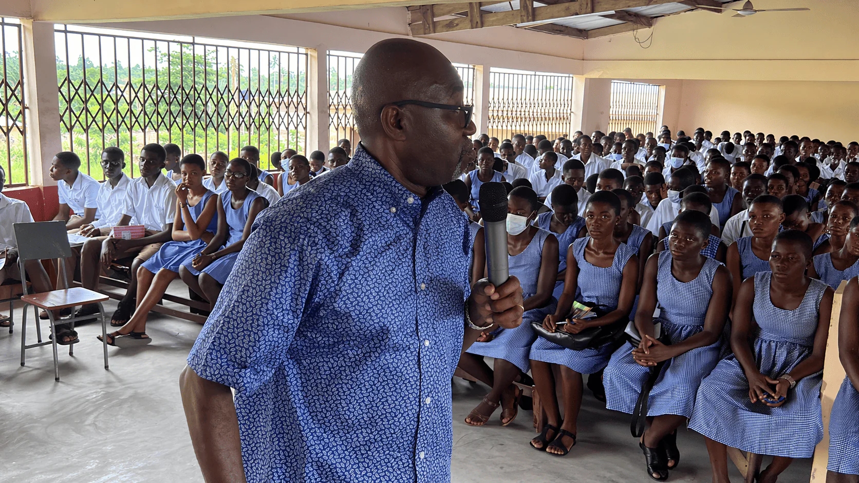 Bishop Fred Adetunji speaking to students during a school outreach session