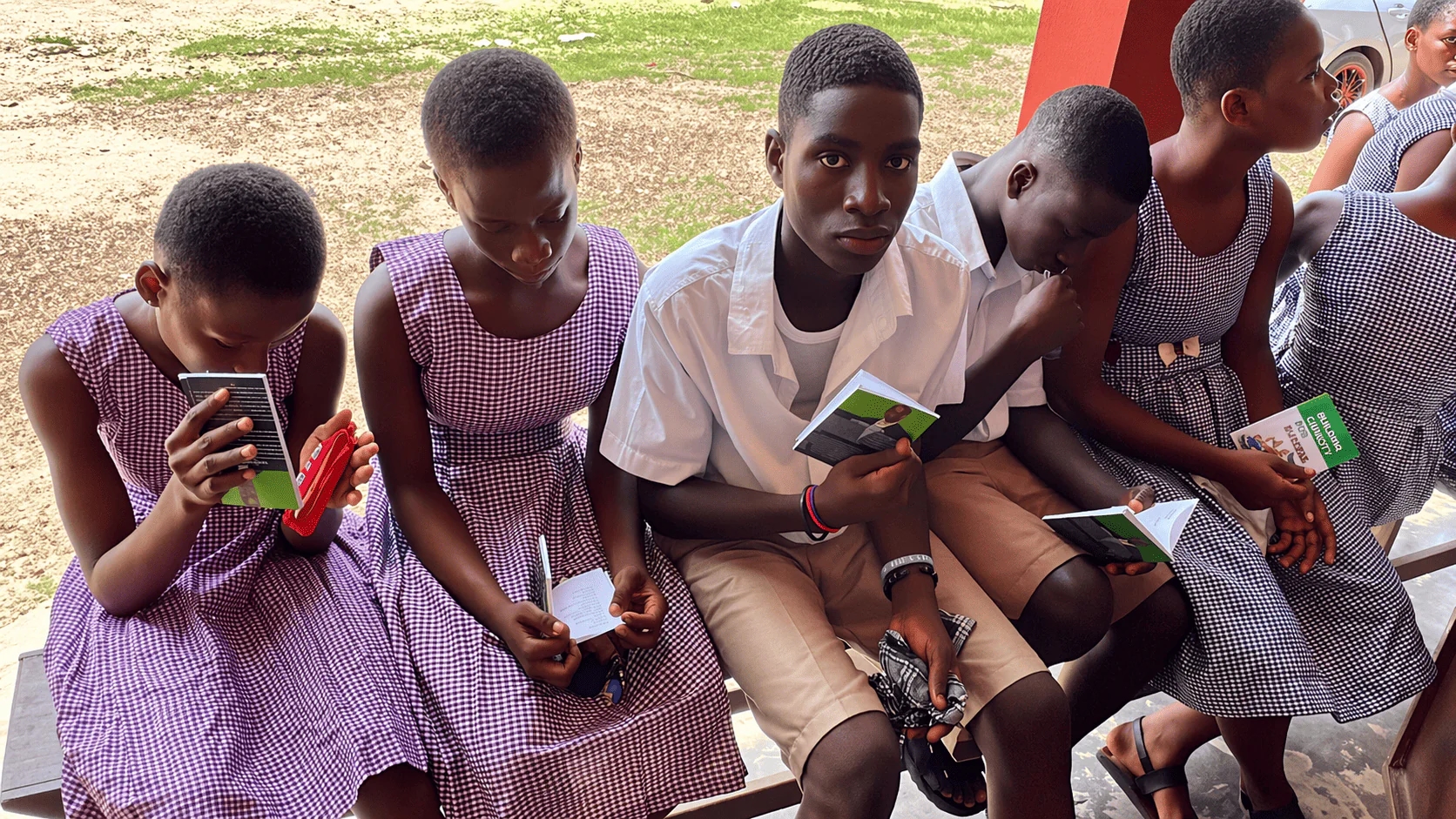 Students reading materials distributed during an Equipping Center outreach